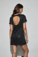Vestido corto negro con lentejuelas y flecos colgantes, de manga corta y cuello redondo.