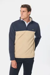 Buzo de polar bicolor azul marino y verde con medio cierre y bolsillos laterales con cierre.