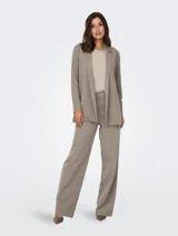 Blazer largo de punto elástico marca JDY, color beige, con cuello de solapas y diseño abierto sin botones.