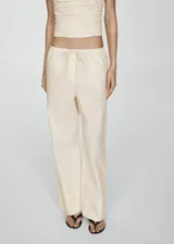 Pantalon wideleg de corte holgado, confeccionado en algodón, con cintura elástica y lazo ajustable.