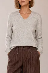 Sweater tejido de punto melange color bordó, con escote en V y mangas largas.