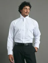 Camisa de vestir de manga larga con cuello rígido y cierre frontal de botones. Presenta un estampado de pequeños puntos azules sobre fondo blanco.