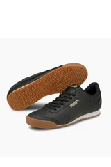 Championes deportivos Puma modelo Turino Fsl, color negro con suela de goma marrón y detalles en dorado.