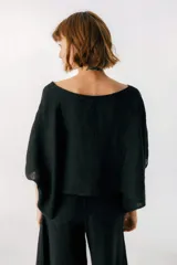 Blusa blanca de lino, con escote bote y corte amplio y holgado.