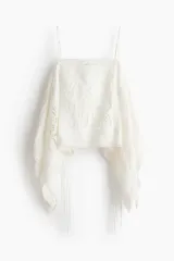 Top blanco de breteles finos confeccionado en algodón con broderie, con escote recto, diseño asimétrico con paneles laterales drapeados y tiras colgantes.