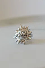 Anillo dorado con forma de sol con rostro, ajustable entre 16mm y 19mm.