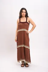 Vestido largo de tejido de punto color marrón, con tirantes anchos, escote cuadrado con detalles en tono bordó y franjas horizontales en color crema con terminación ondulada.