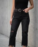 Cinto de dama de símil cuero negro, con ojales metálicos y una hebilla grande con diseño ornamental de estilo western.