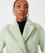 Saco cruzado de mujer color verde menta, con cuello solapa y manga larga. Presenta bolsillos frontales con solapa y cierre de botón.