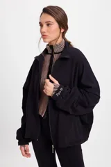 Campera holgada de felpa con spandex, diseño de manga murciélago, cuello alto y cierre frontal completo. Presenta detalle bordado en el puño.