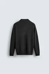Polo de punto de corte regular fit, confeccionado en una mezcla de lana y cashmere. Presenta cuello solapa con cierre frontal de dos botones, manga larga y terminaciones en rib.