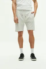 Short de felpa azul marino con textura, bolsillos laterales y uno trasero, cintura regulable con cordón y logo bordado.