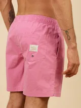 Short de baño color beige, de corte volley, con cintura elástica y cordón ajustable. Presenta un pequeño logo bordado en la parte inferior de la pierna izquierda.