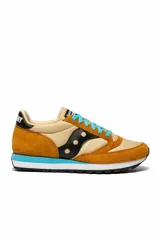 Zapatillas Saucony Jazz Original color mostaza, beige y negro, con cordones celestes.