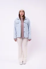 Campera de jean color celeste claro, con cuello camisero, botones frontales y bolsillos con solapa en el pecho.