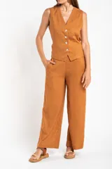 Pantalón de lino color tostado, de corte recto y tiro medio.