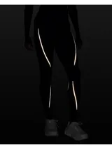 Calza deportiva de tiro alto color marrón oscuro, confeccionada en tejido de doble punto con interior cepillado para mayor calidez. Presenta paneles acanalados estratégicos y detalles de cinta reflectante en las piernas.