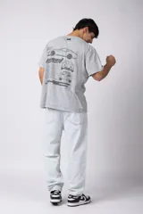 Remera de algodón con efecto de lavado snow-wash en color gris. Presenta un diseño de cuello redondo, mangas cortas y un estampado frontal minimalista con gráficos de estilo automovilístico y cuadros de meta.