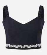 Blusa cropped negra de lino y algodón, con escote corazón, breteles anchos y detalle de bordado ondulado en el ruedo.