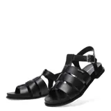 Sandalias tipo franciscanas de cuero gamuzado color marrón, con tiras anchas entrelazadas, cierre lateral con hebilla metálica y suela plana negra.
