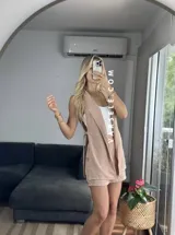 Conjunto color naranja compuesto por un chaleco sin mangas con solapas y un short de tiro alto con elástico en la parte trasera.