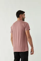 Remera de manga corta color gris claro con cuello redondo y estampado de tres fotos en blanco y negro en el frente.