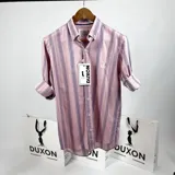 Camisa de vestir de manga larga, color rosa con rayas verticales en tonos de gris y blanco. Tiene cuello italiano, cierre con botones y logo bordado en el pecho.