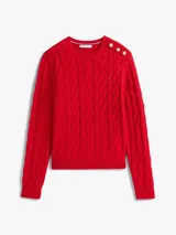 Sweater de punto con diseño de trenzas, cuello redondo y detalle de botones dorados en el hombro. Presenta terminaciones acanaladas en puños y dobladillo, con el logo de la marca bordado en el pecho.