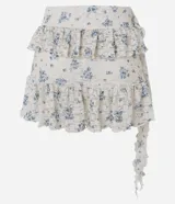 Pollera corta evasé de encaje floral Liberty, con volados asimétricos en capas y forro interno.