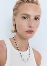 Top de canalé de mezcla de algodón y lyocell, de corte entallado, sin mangas y con cuello halter y tirantes anchos.