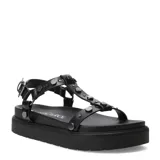 Sandalias planas Miss Carol estilo flatform, color negro con tachas metálicas en las tiras y suela chunky acanalada. Cuenta con cierre de hebilla ajustable en el tobillo.