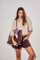 Sweater de tejido abierto de algodón, color beige, con cuello polo, mangas cortas y detalles en color marrón oscuro en los bordes y puños.