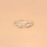 Anillo de plata 925 con forma de infinito y detalle de circonias engarzadas.
