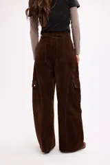 Pantalón cargo de tiro medio, confeccionado en terciopelo negro. Presenta corte amplio, bolsillos laterales con solapa y cierre frontal con botón y cremallera.