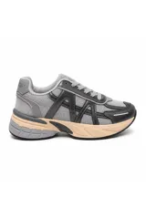 Zapatilla urbana estilo chunky en tonos gris, negro y beige, confeccionada en malla y material sintético, con cordones grises y suela robusta bicolor.