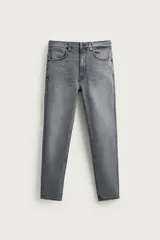 Jeans skinny cropped fit de hombre, color gris con efecto lavado. Confeccionados en tejido elástico, cuentan con diseño de cinco bolsillos, tiro medio y cierre frontal con cremallera y botón.