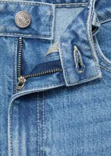 Jeans de tiro alto con corte mom-fit, diseño crop y cinco bolsillos. Presenta cierre frontal con cremallera y botón, y trabillas para cinturón.