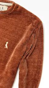 Buzo de chenille color ladrillo, de corte recto y cuello redondo.