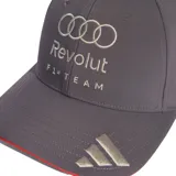 Gorra de béisbol gris con visera curva, detalle de borde rojo y logos bordados de Audi, Revolut y Adidas en color plateado.