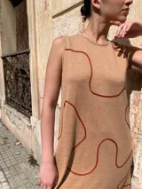 Vestido midi sin mangas color beige con estampado de líneas onduladas color ladrillo.