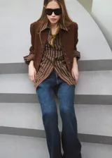 Camisa de algodón con diseño de rayas verticales en tonos marrón y beige, de manga larga, cuello camisero y cierre frontal de botones.