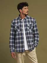 Camisa a cuadros azul marino, con cuello abotonado, manga larga y dos bolsillos con solapa abotonada en el pecho.