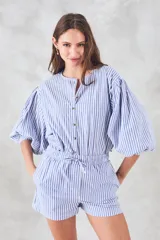 Camisa celeste a rayas verticales blancas, de corte holgado y mangas 3/4 abullonadas.