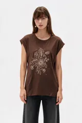 Remera negra de algodón, con cuello redondo, mangas cortas holgadas con vuelta y estampa floral grande en el pecho.
