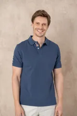 Chomba azul de piqué de algodón con cuello polo, tapeta de dos botones con diseño estampado en el interior y mangas cortas. Corte clásico.