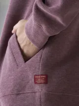 Buzo tipo hoodie con cierre frontal completo, capucha con cordones ajustables y bolsillos laterales. Confeccionado en tejido de algodón con textura jaspeada.