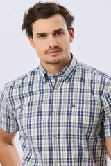 Camisa de manga corta con estampado de cuadros en tonos azules, rojos y blancos, cuello con botones y bolsillo ojal en el pecho con logo bordado.