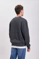 Campera deportiva gris oscuro de corte bomber con cierre frontal y cuello redondo. Confeccionada en tejido de punto con efecto lavado.