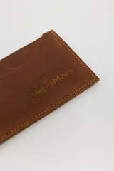 Tarjetero de cuero con diseño animal print en el frente y cuero liso marrón oscuro en la parte posterior, con compartimentos para tarjetas en ambos lados.