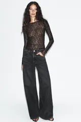 Jeans de tiro medio y corte wide leg en color marrón oscuro, con diseño de cinco bolsillos y cierre frontal con cremallera y botón metálico.